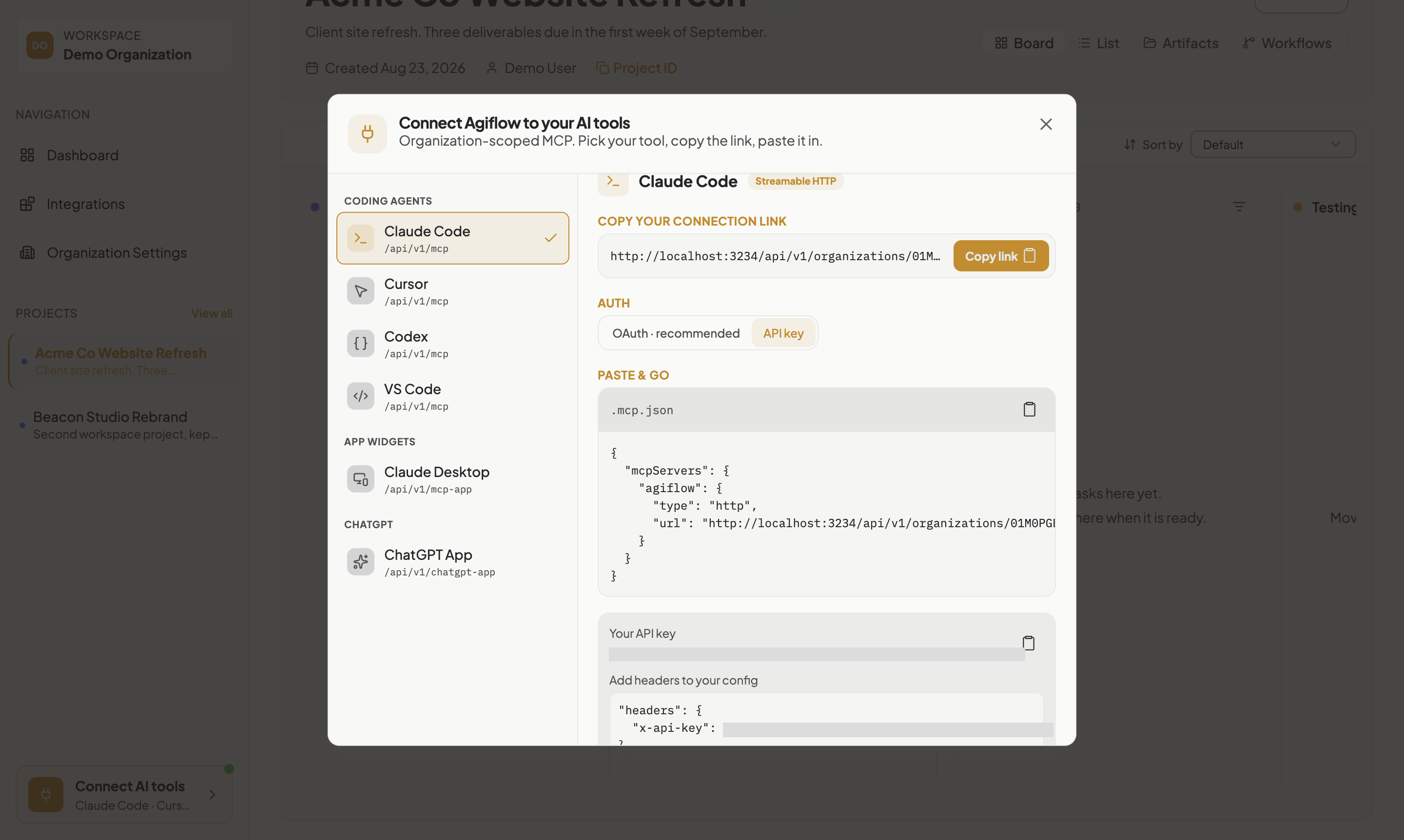 Connect AI tools dialog with API key auth selected, showing the organizations-scoped connection link, the .mcp.json paste-and-go block, and a generated API key panel with the key value masked.